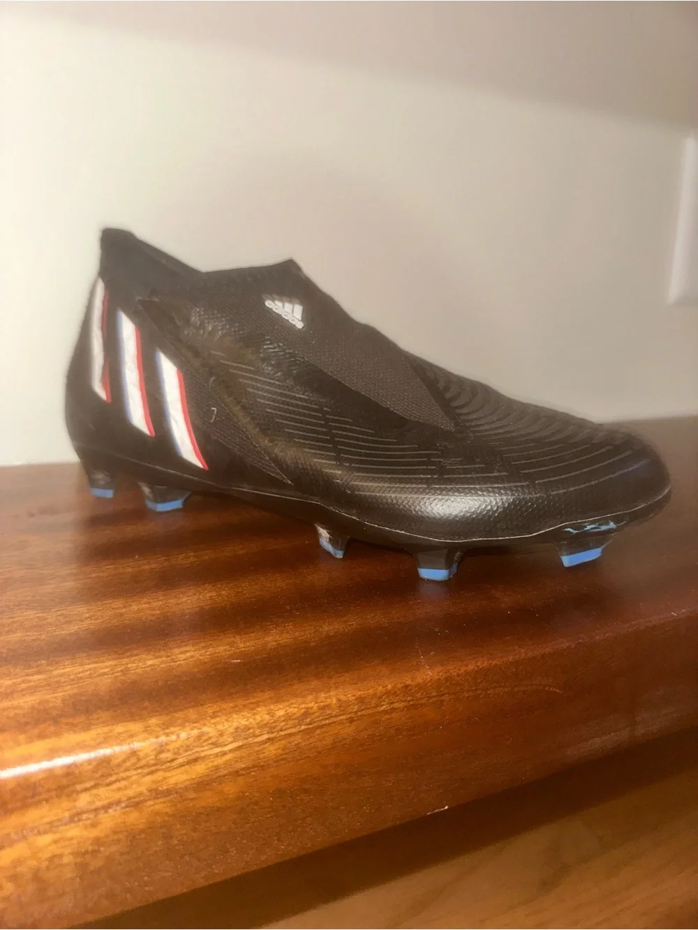 adidas Black Soccer Cleat with Blue and Red Stripe Accents